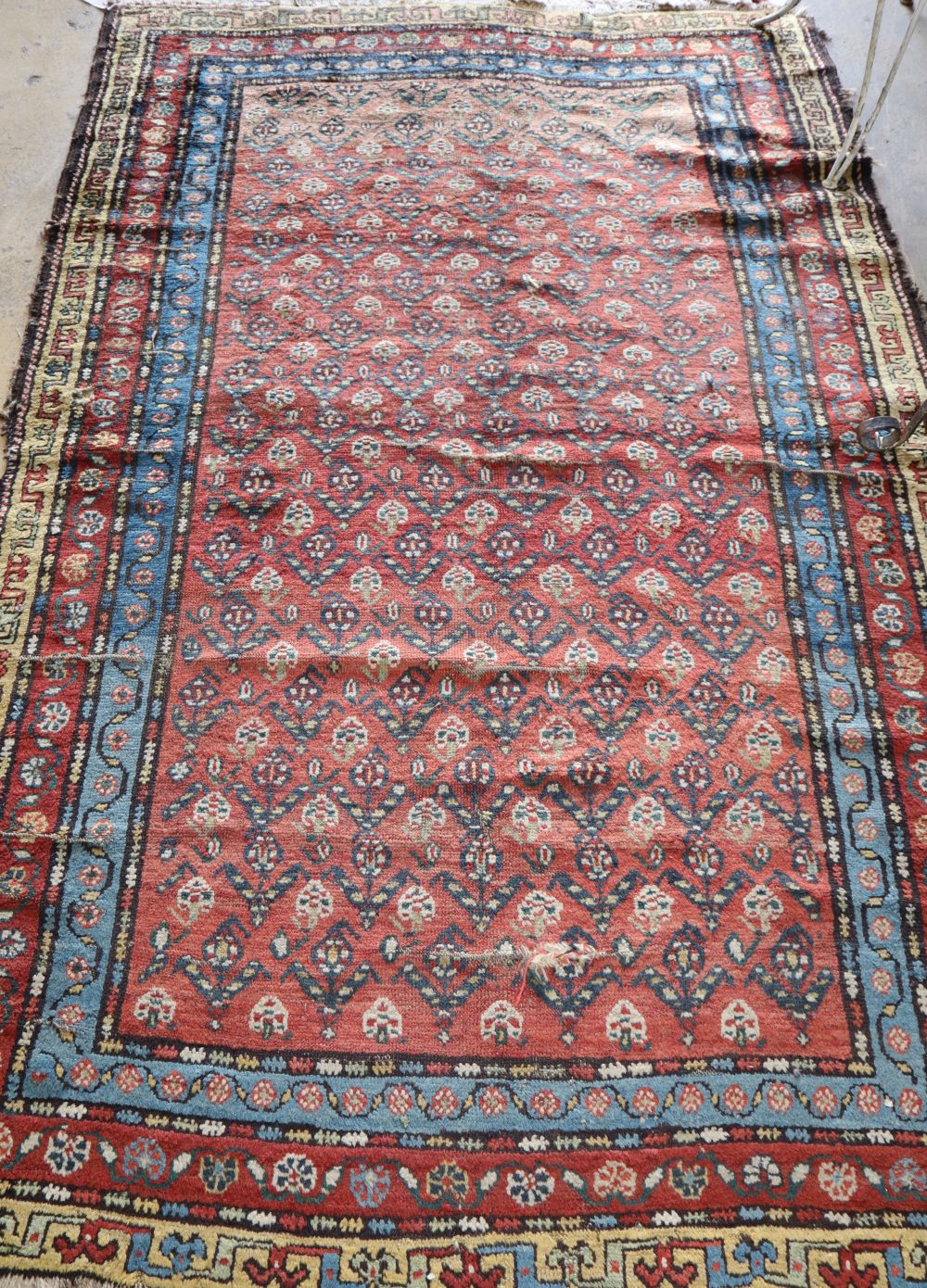 A Kurdish red ground rug, 220 x 140cm